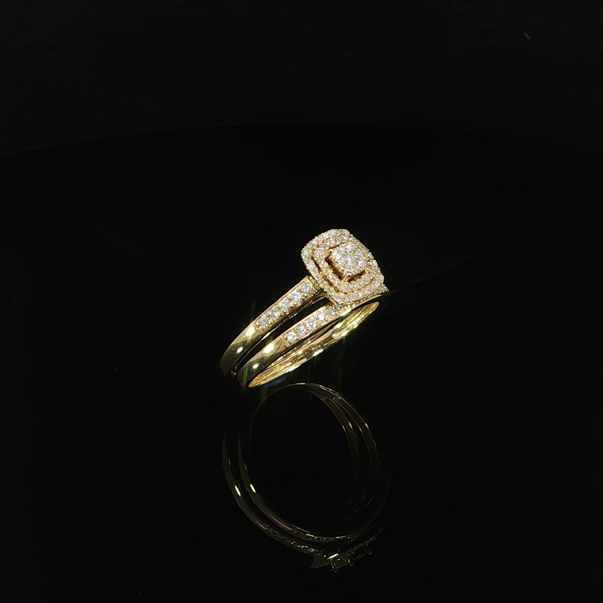 Angled profile of a 0.33 CTW natural diamond bridal set with a raised double halo and matching yellow gold band.
