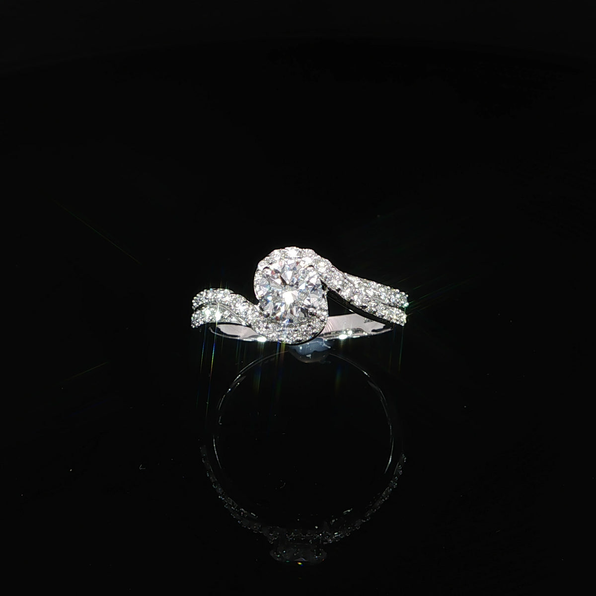 14K white gold bypass engagement ring with a 0.50 carat round lab grown diamond and pavé diamond accents.