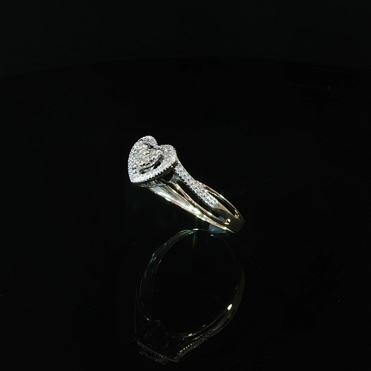 Angled view of a 0.10 CTW diamond promise ring in 10K yellow gold showing the heart design and diamond-set shoulder.