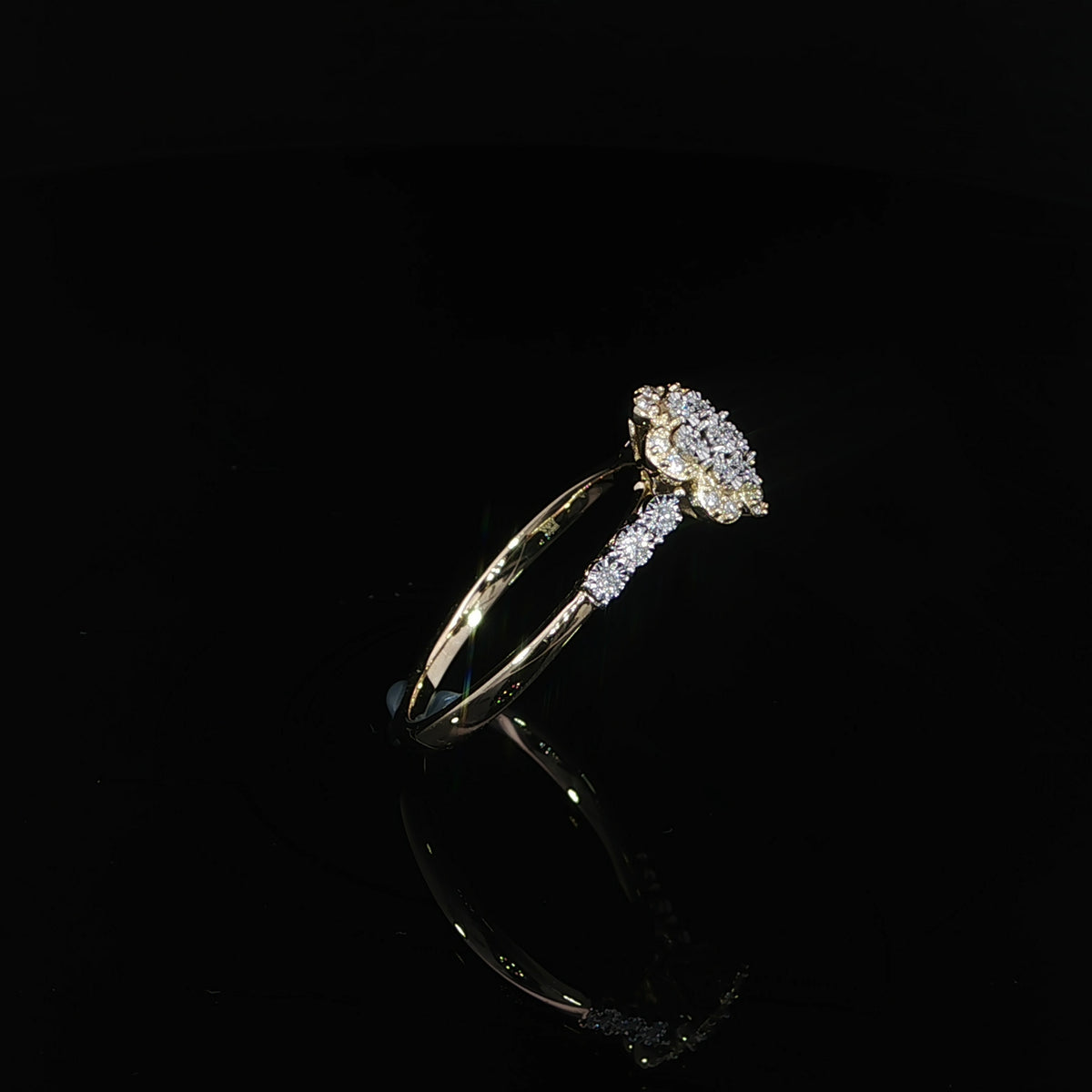 A 10K yellow gold 0.14 CTW natural diamond promise ring viewed from the side, showing the floral head and polished lower band.