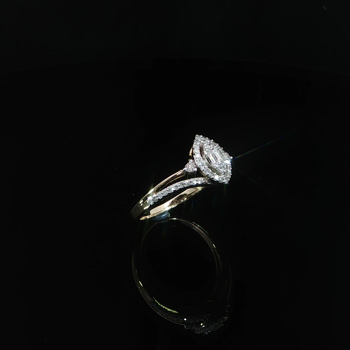 Three-quarter view of a 0.29 CTW natural diamond halo ring in 10K yellow gold showing the split shoulders.