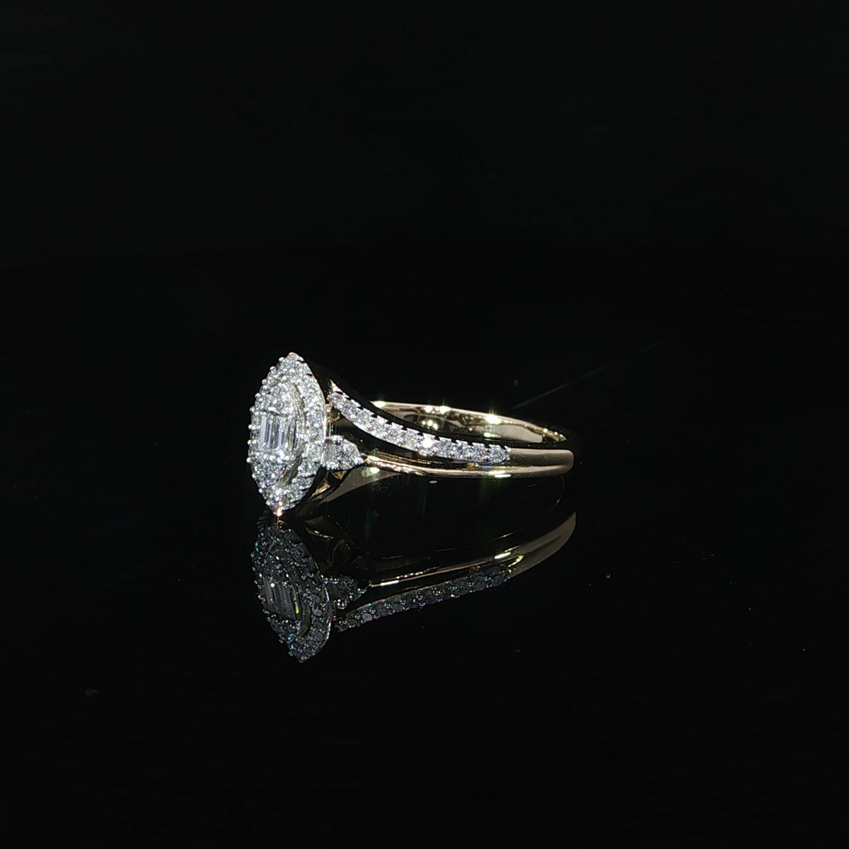 Side view of a 0.29 CTW diamond illusion ring in 10K yellow gold with a marquise-shaped head and split band.
