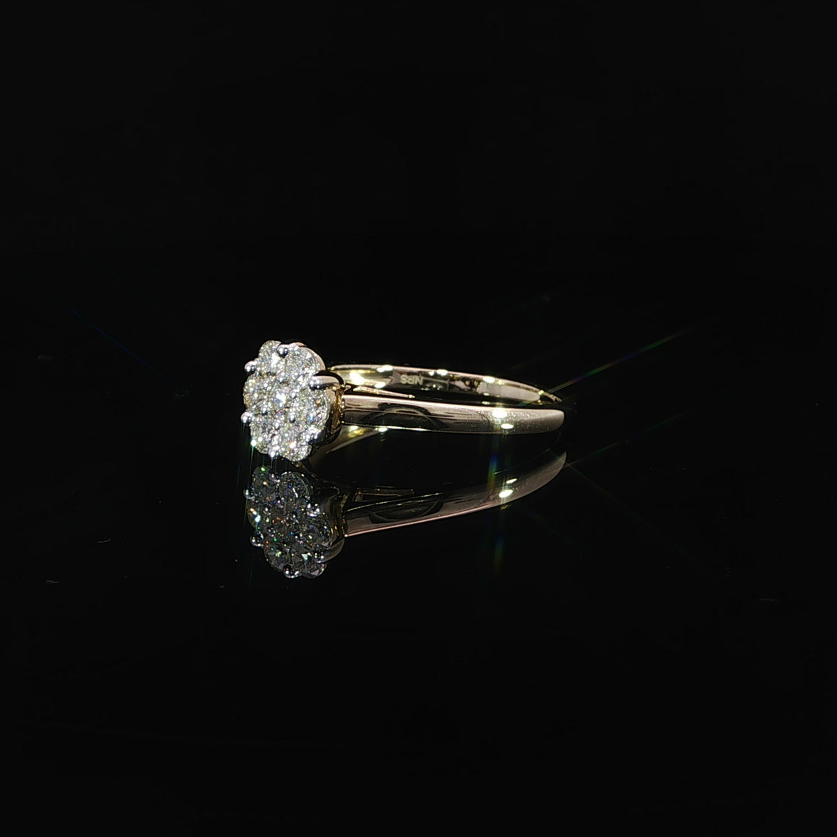 Resting side angle of a 0.50 CTW round cluster ring in 10K yellow gold showing the diamond arrangement and smooth shoulder.