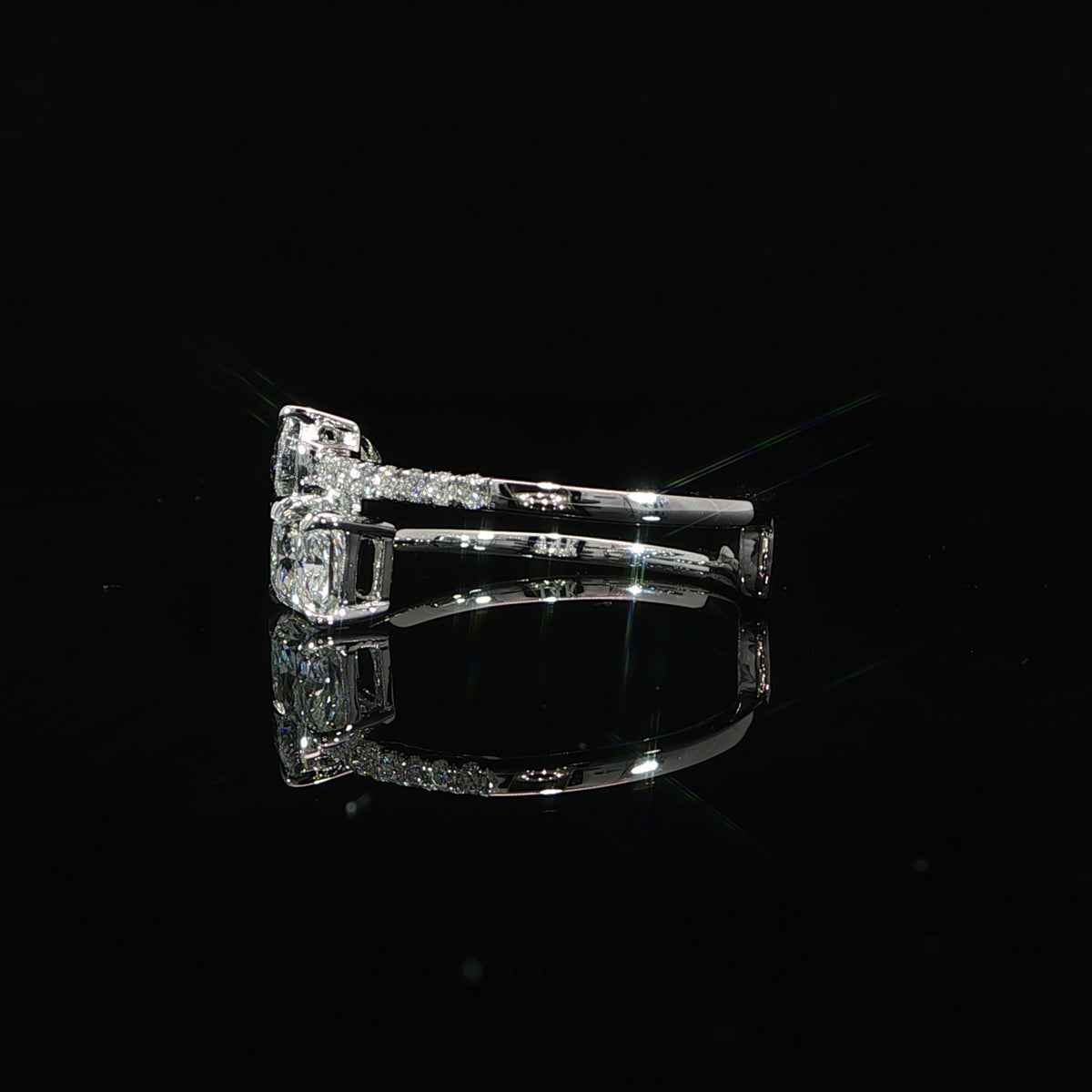 Side profile of a Toi et Moi engagement ring showing the radiant and pear diamond settings.