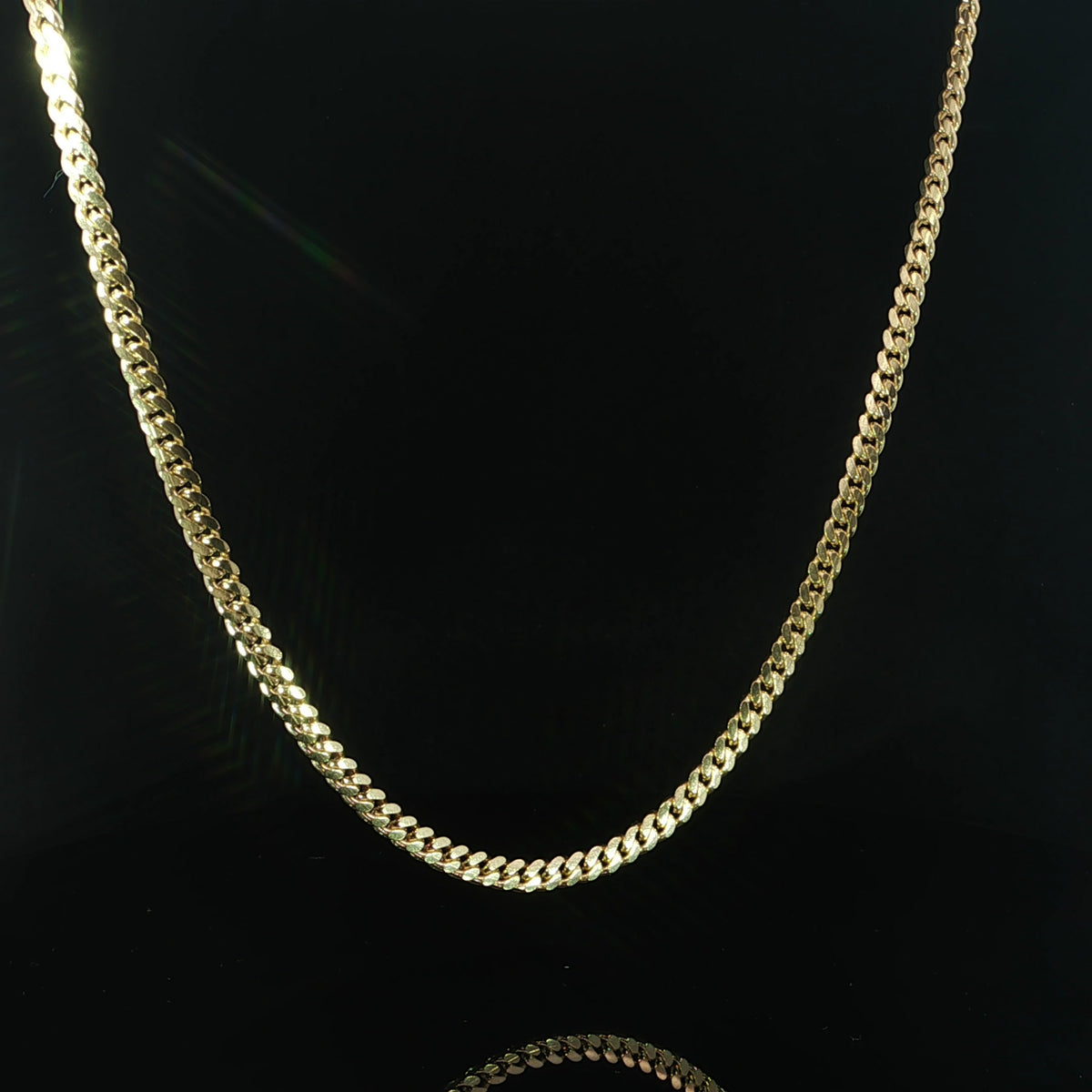 Angled view of a solid 10K yellow gold Cuban necklace