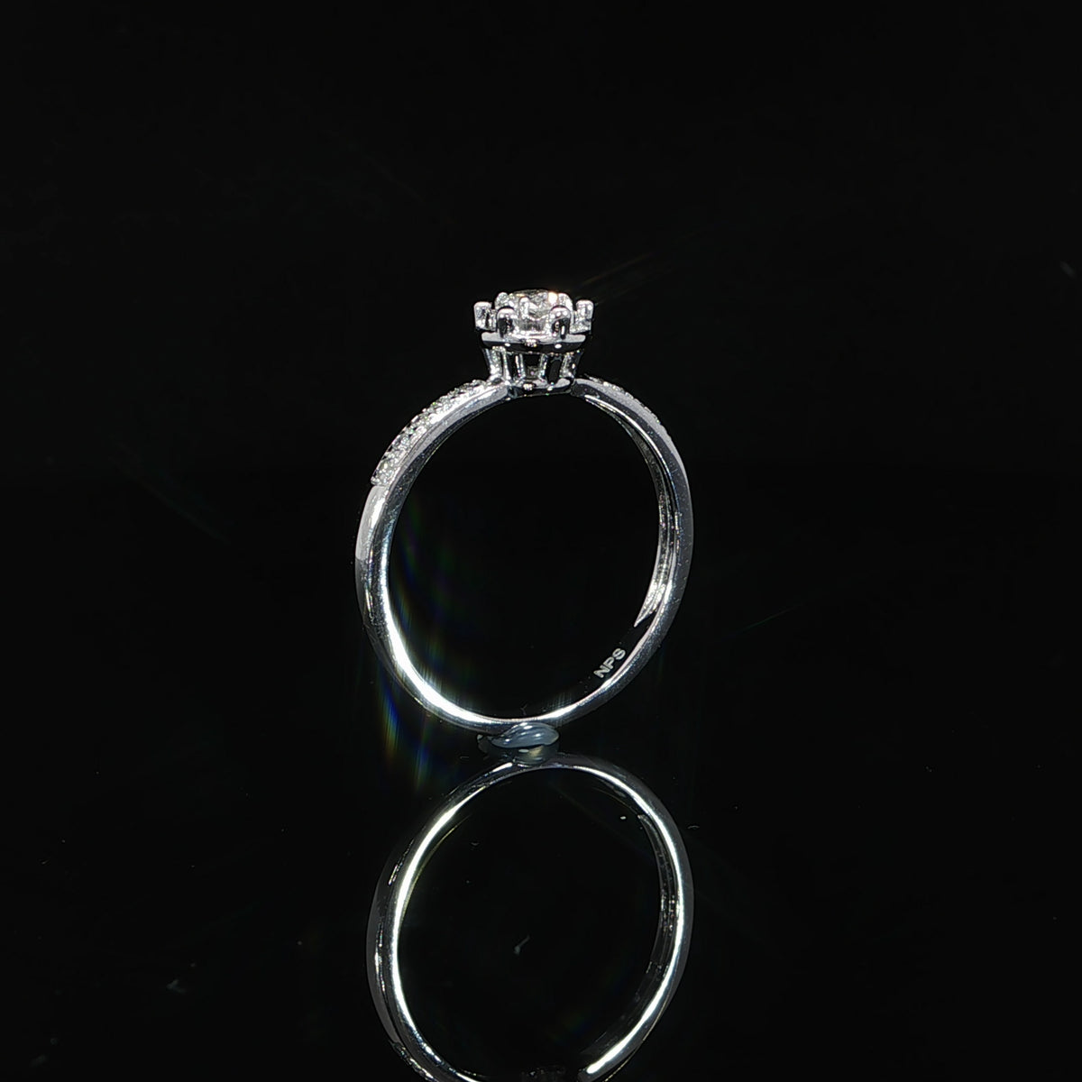 Side view of a 10K white gold 0.22 CTW diamond illusion ring revealing the open gallery beneath the round setting.