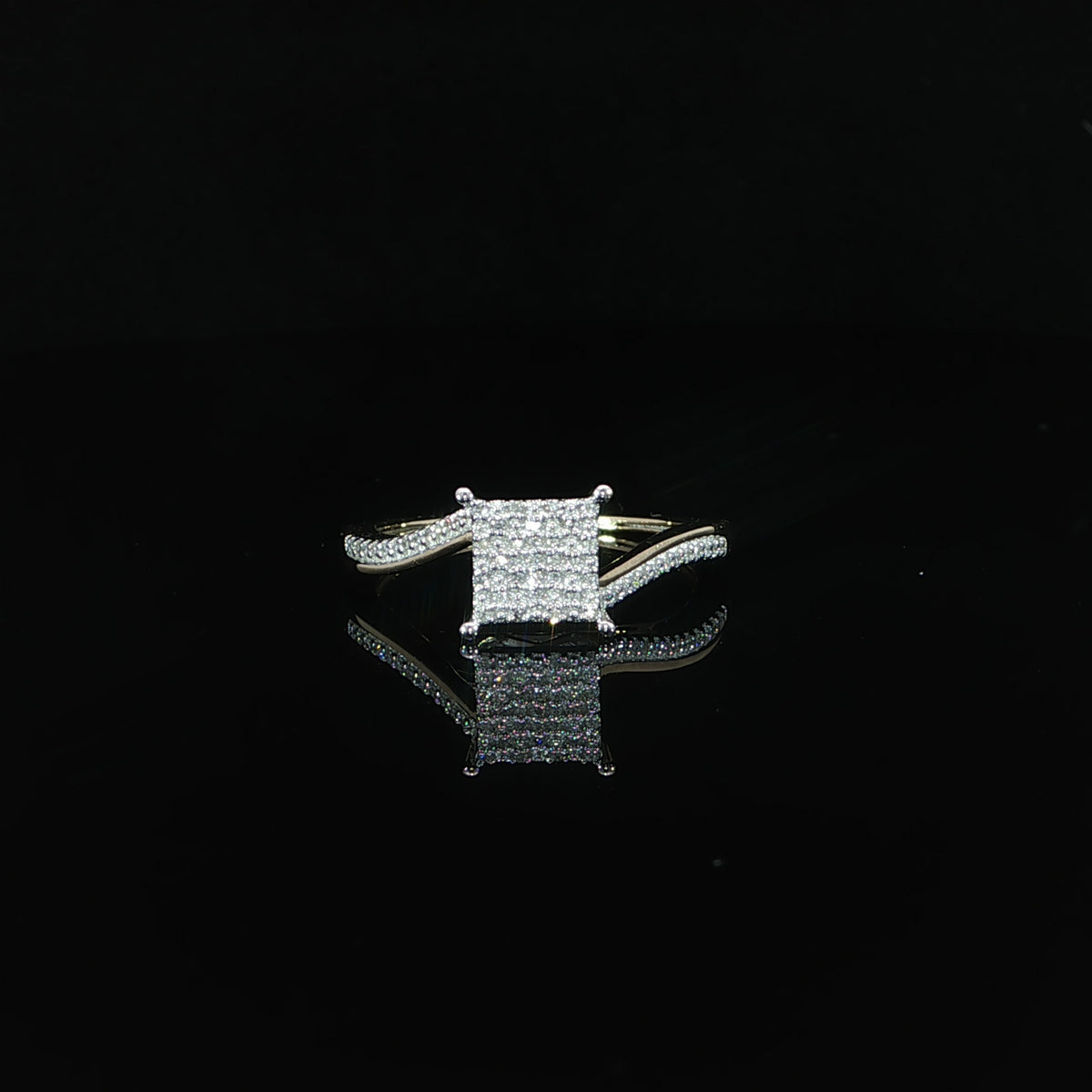 Resting front view of a 10K yellow gold cluster ring with 0.11 CTW of natural diamonds.