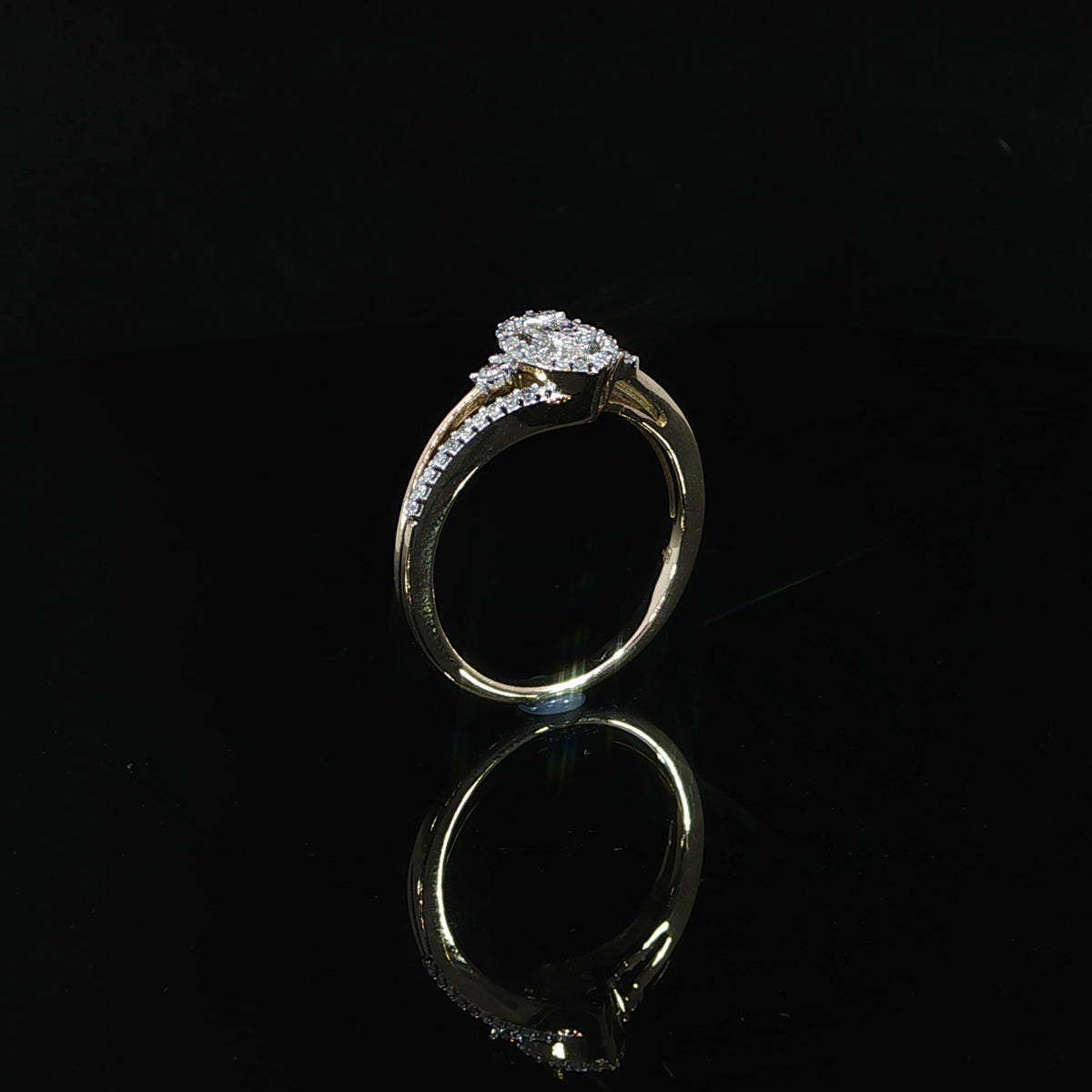 Side view of a 10K yellow gold 0.29 CTW diamond ring showing the split shoulder beneath the marquise-shaped head.