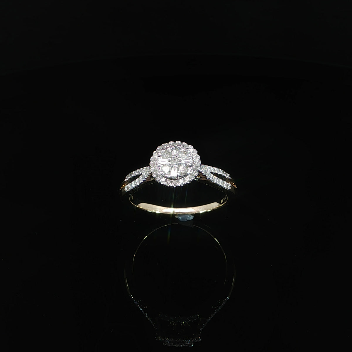 Face-on view of a 10K yellow gold 0.40 CTW diamond halo ring with open split shoulders.