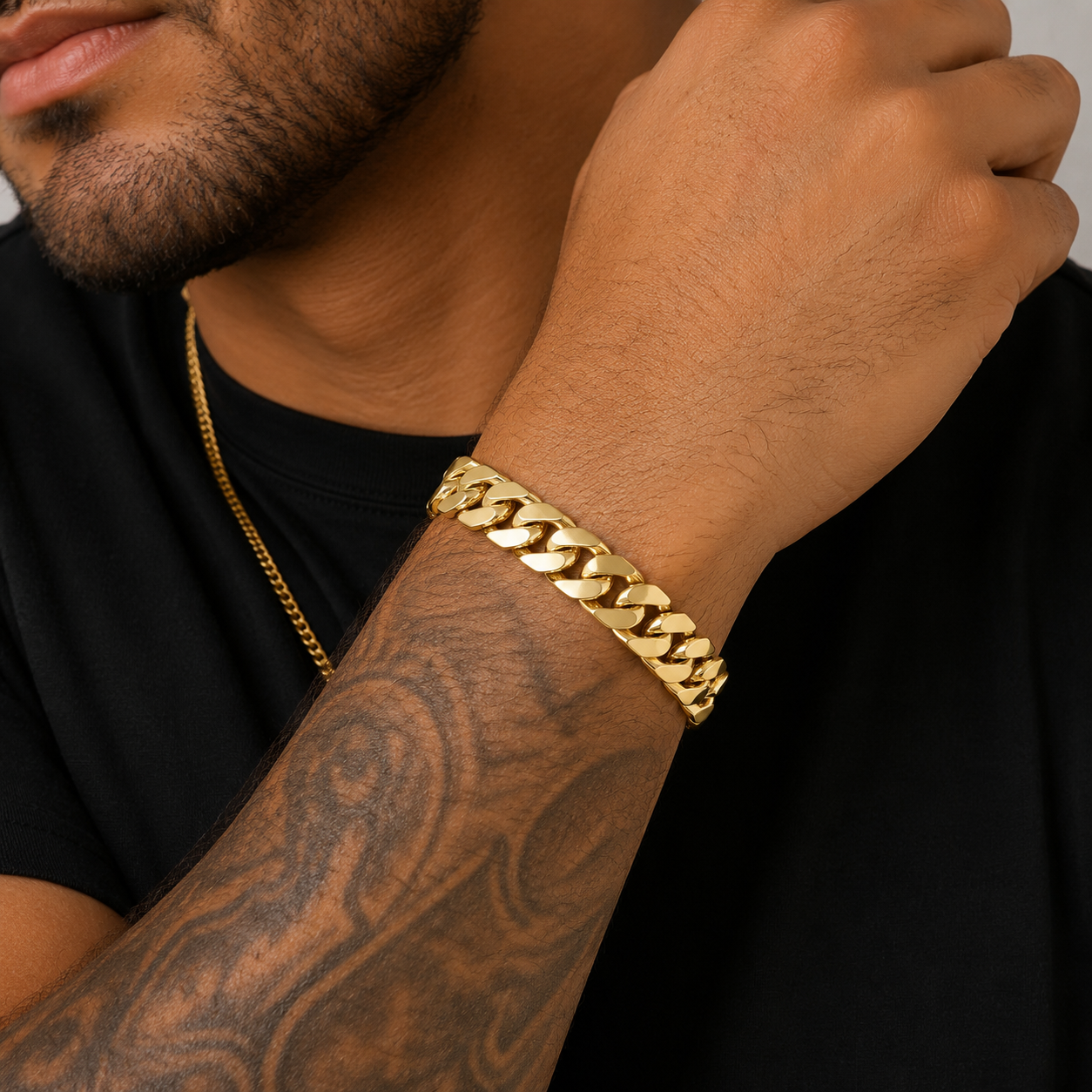 Model wearing heavy 10MM Miami Cuban link bracelet in 10K yellow gold