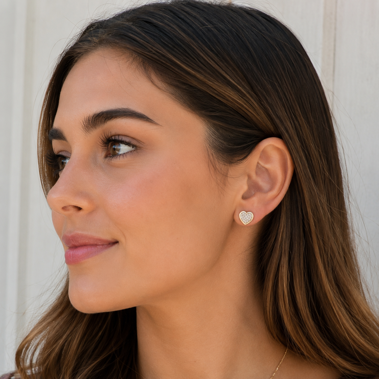 Model wearing diamond cluster heart earrings