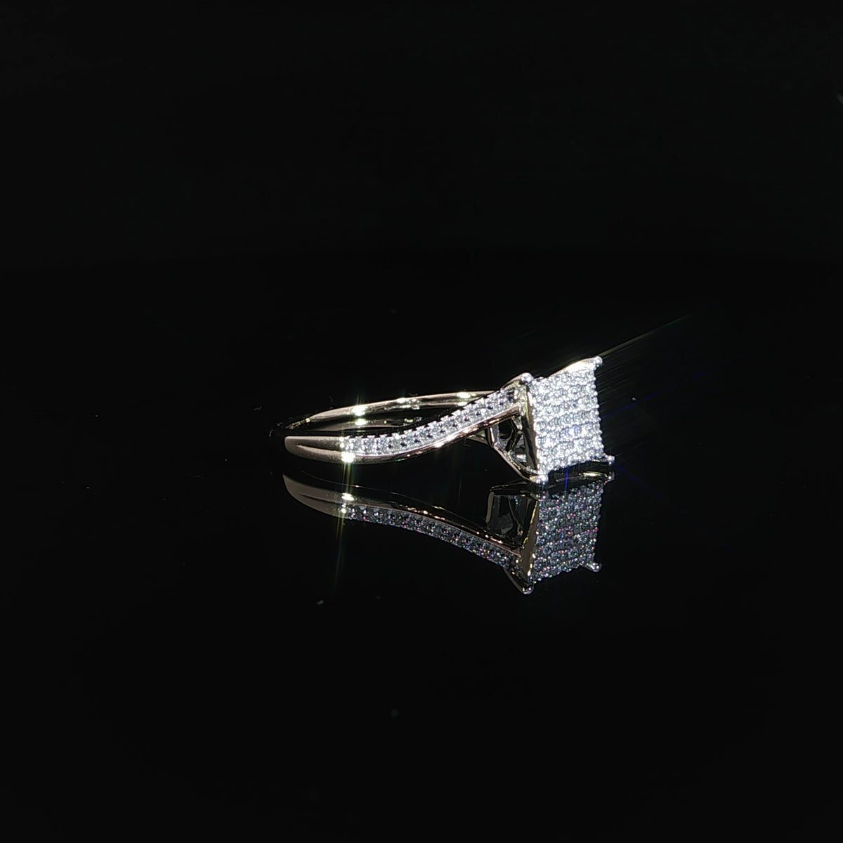 Side profile of 10K yellow gold ring with rows of small diamonds across its square head and curved shoulders.