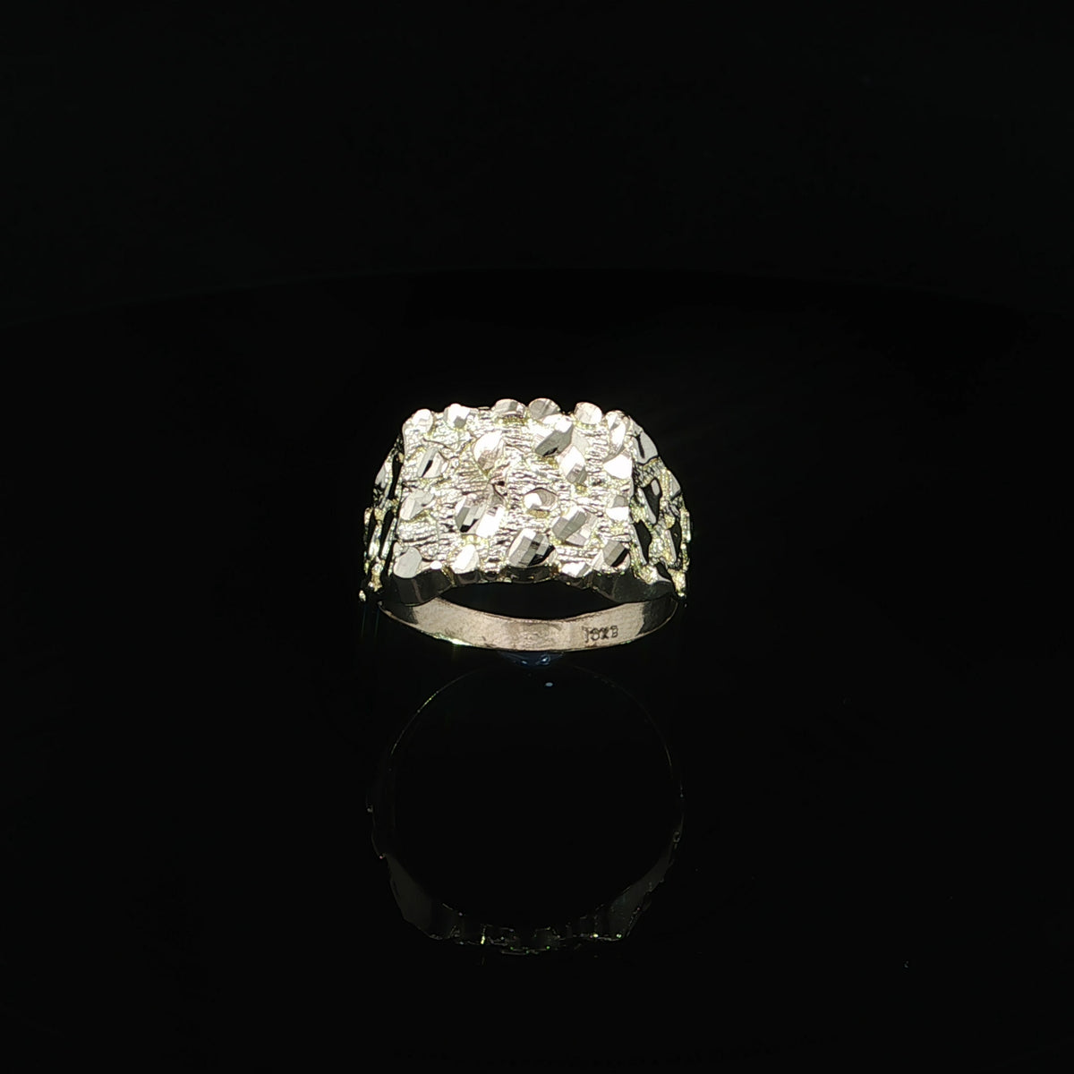 Front view highlighting the contrasting polished and textured surfaces of a yellow gold nugget ring.