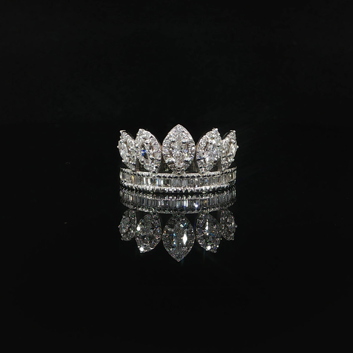Front view of five marquise diamond crown points above a row of baguette diamonds.