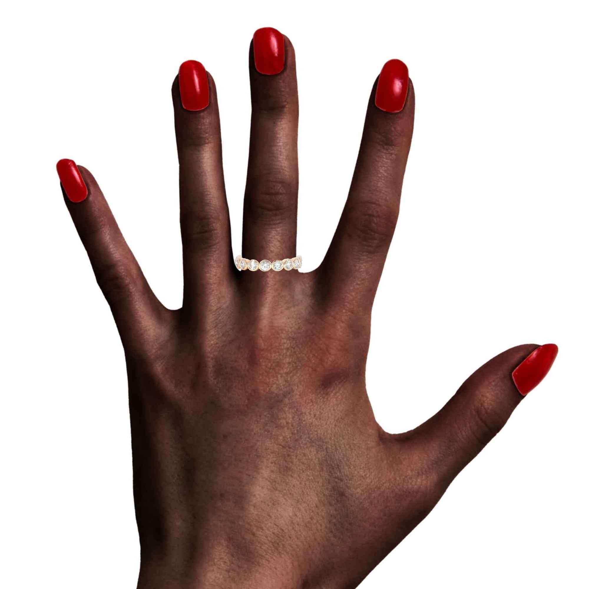 Model wearing modern round bezel diamond band in 14K rose gold with 0.87 ctw
