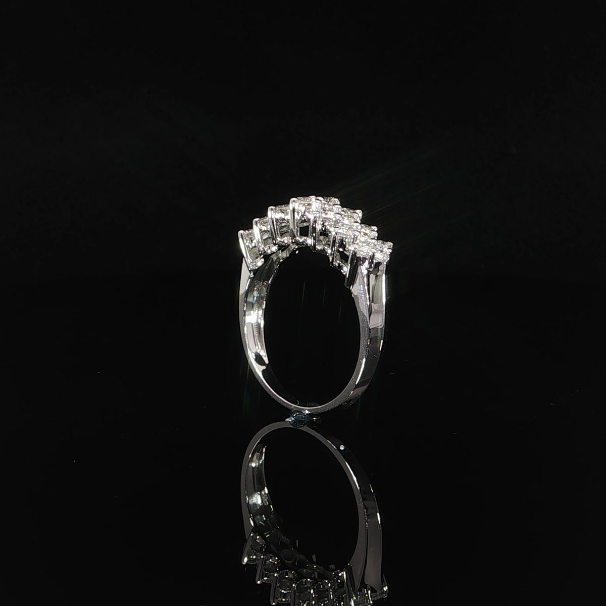 Side profile of a 14K white gold diamond anniversary band showing its open gallery and raised settings.