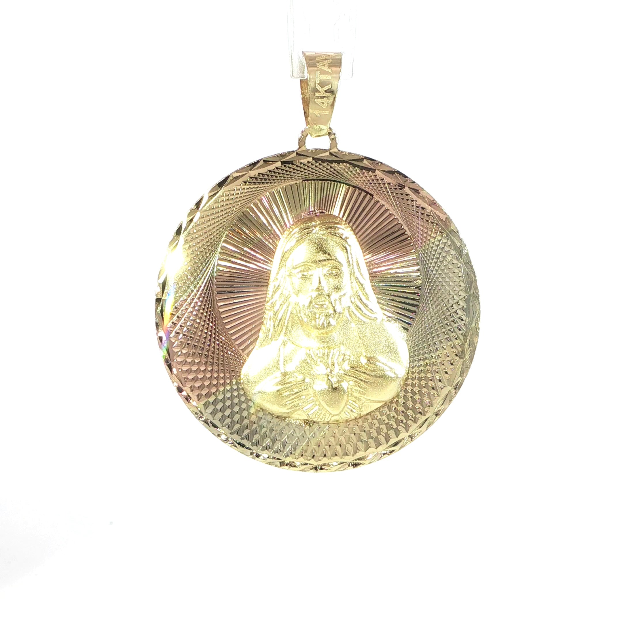 Close-up view of Sacred Heart of Jesus religious medallion in tri-color gold
