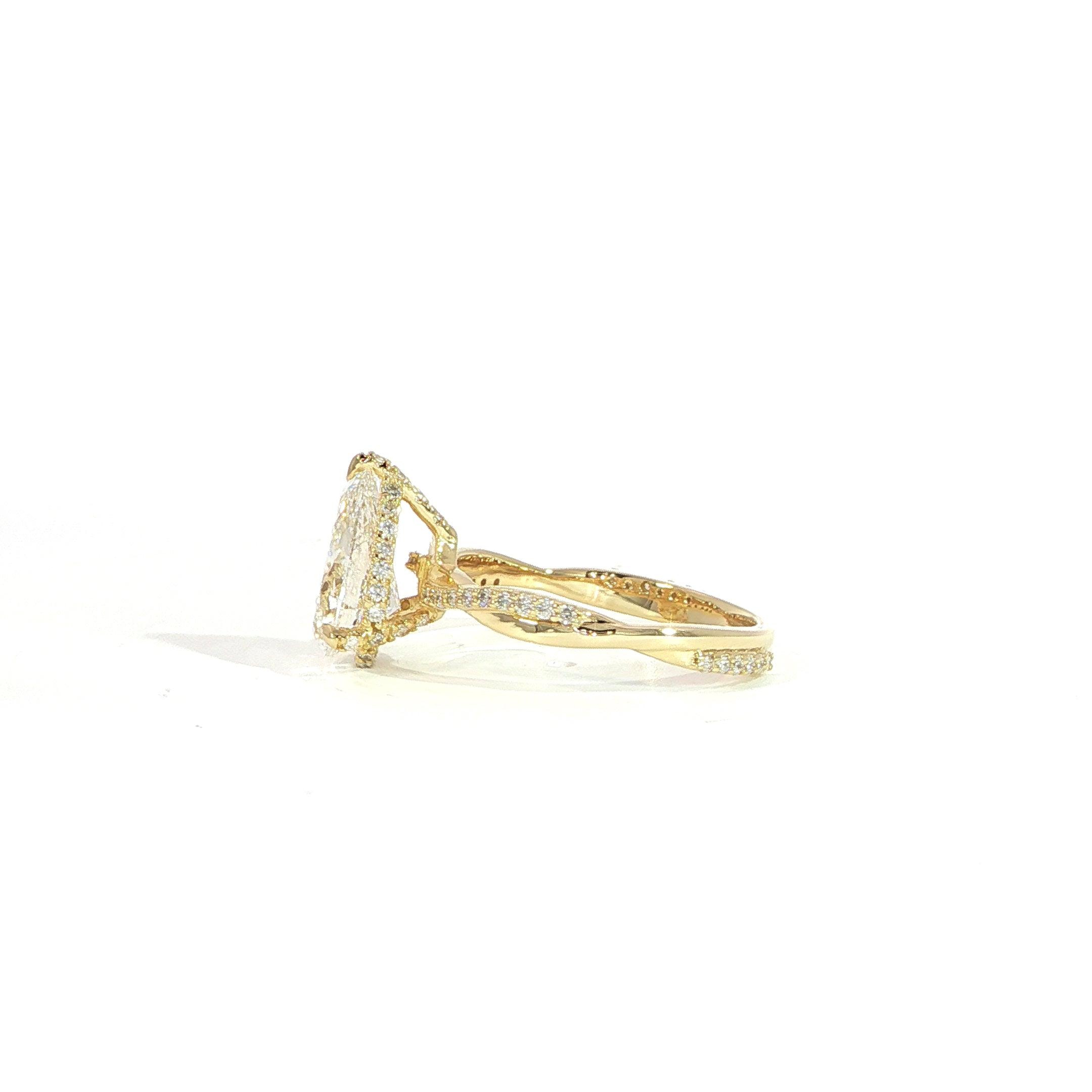 Side view of 14K yellow gold pear diamond engagement ring