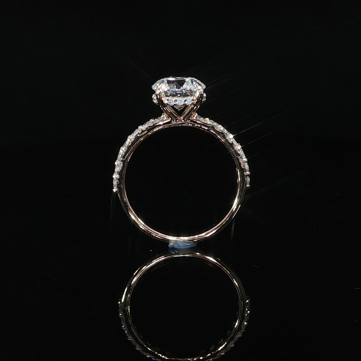 Side details of round engagement ring with 2.67 total carats of lab-grown diamonds set in 14K rose gold.