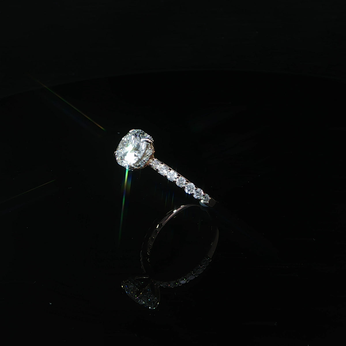 Angled view of a 14K rose gold engagement ring with a 2.10-carat round center diamond on a diamond band.