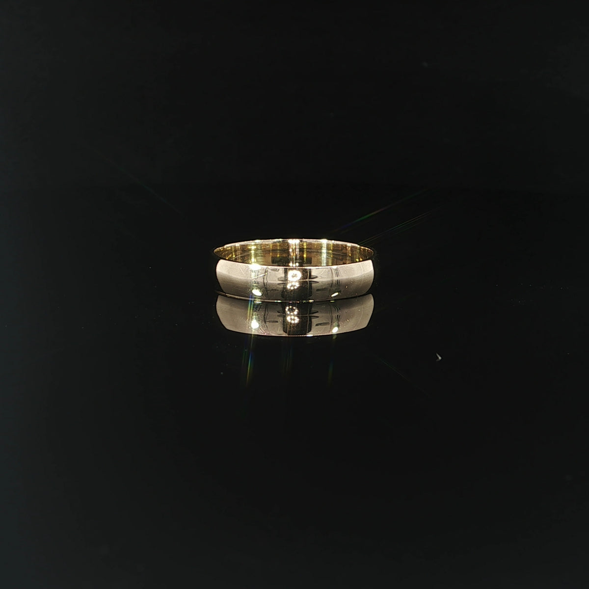 Front view of a classic 14K solid gold 4mm wedding band featuring a plain, highly polished surface with a gently rounded profile.