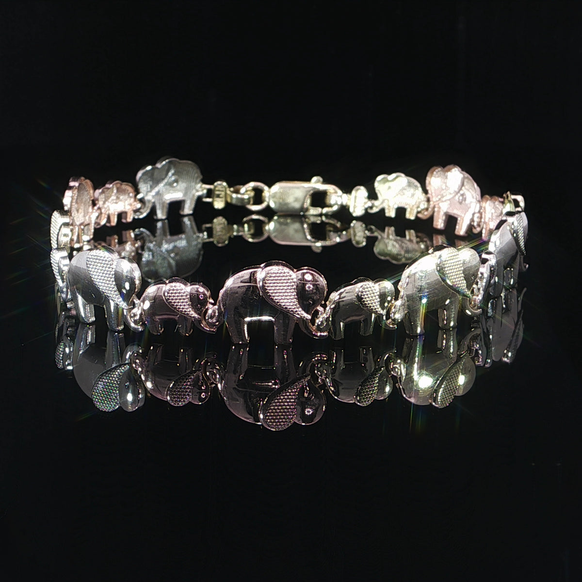14K three-color gold bracelet featuring alternating adult and baby elephant links.