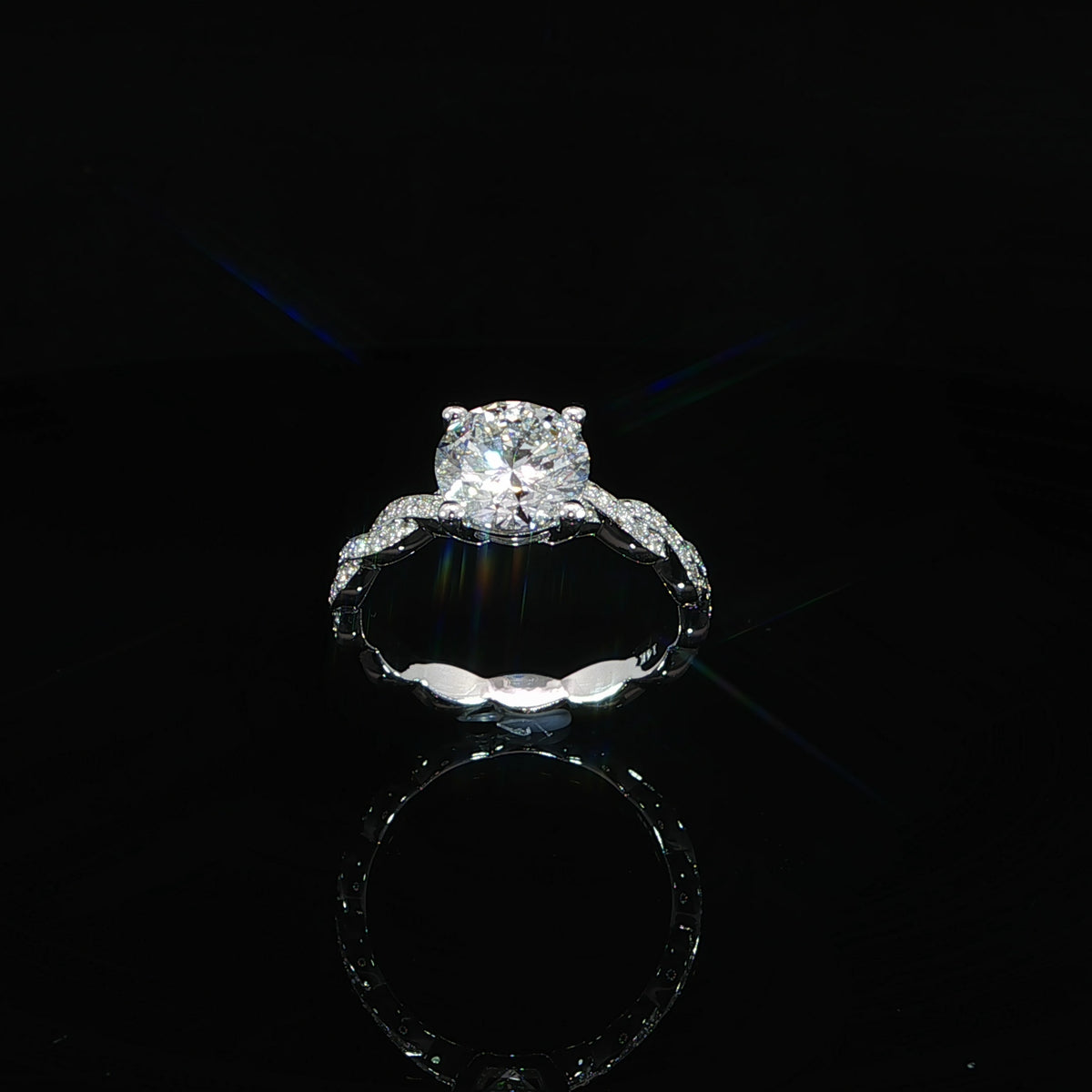 Round lab-grown diamond in a four-prong setting above a twisted white gold diamond band.