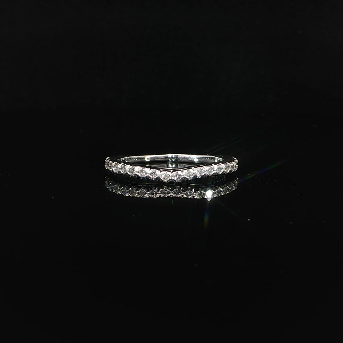 Front view of a curved diamond wedding band in polished 14K white gold with 0.25 CTW sparkling lab grown diamonds.