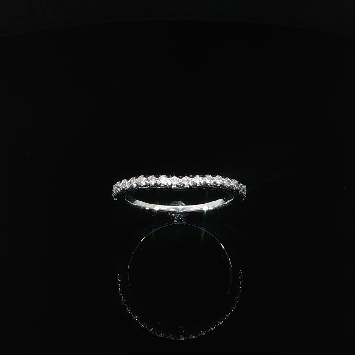Angled view of a 14K white gold diamond contour band featuring 0.25 CTW lab grown diamonds along a gently curved setting.