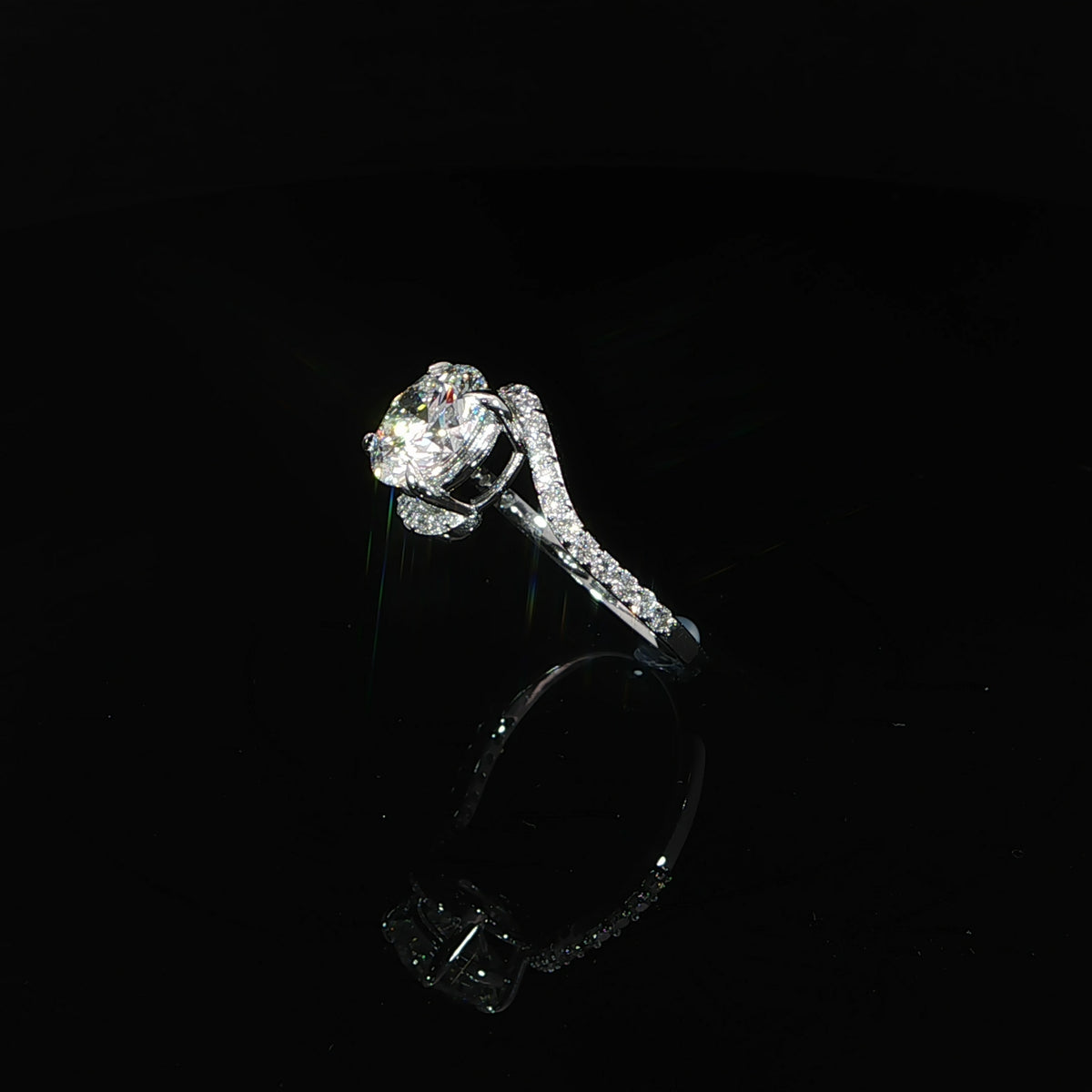 Angled view of a 14K white gold bypass ring featuring a 2-carat round center diamond.