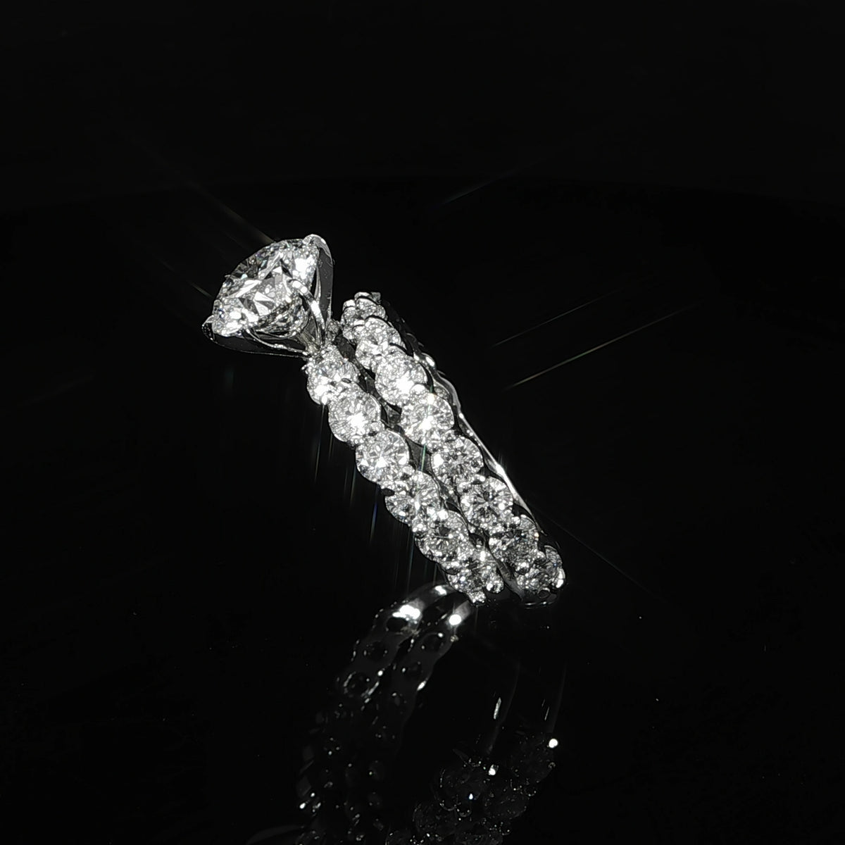 Six-prong round diamond wedding set shown from an angle