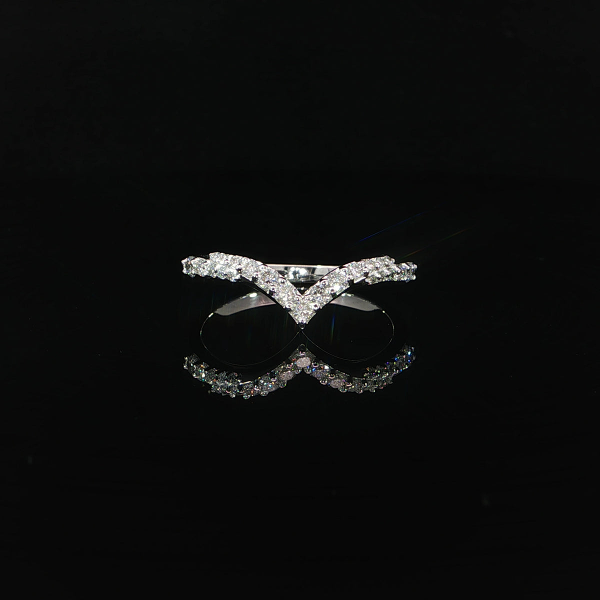 Front view of a 14K white gold diamond contour band with a pointed V-shaped center.