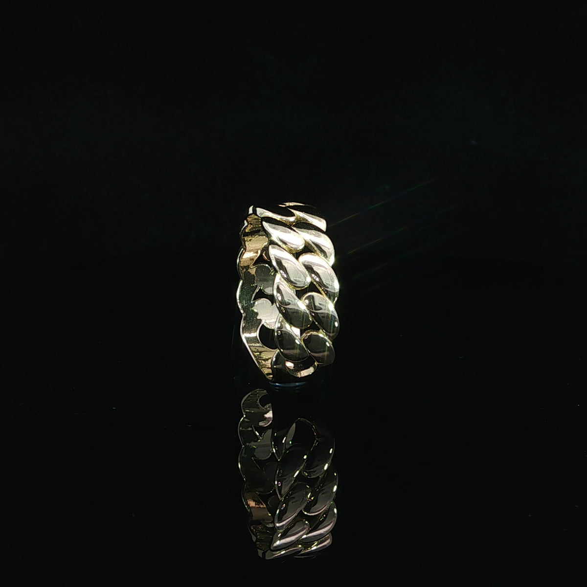 Straight front view of an 8mm wide 14K yellow gold Cuban chain ring displaying bold interlocking links, reflective surfaces, and a polished gold interior.