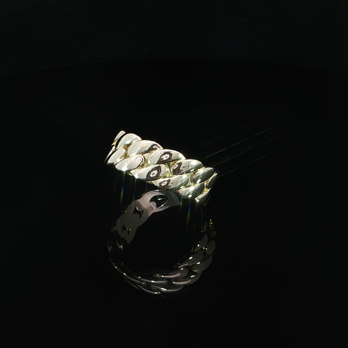 Three-quarter angled view of a 14K yellow gold Cuban link ring featuring an 8mm wide interlocking chain design with polished, rounded links.