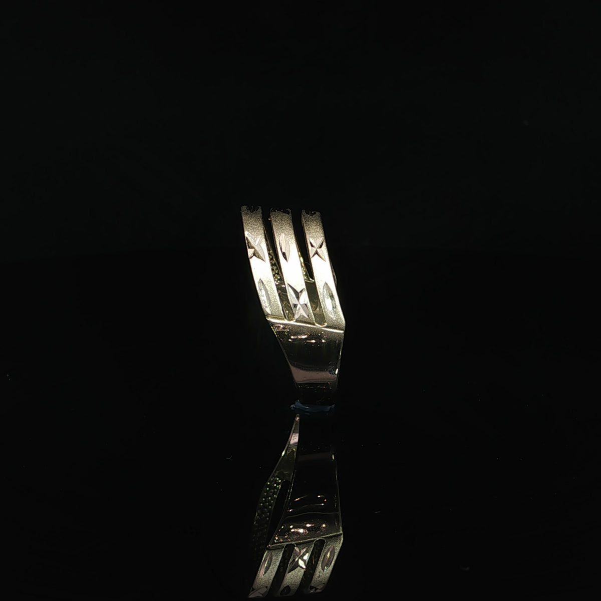 8mm yellow gold ring featuring textured rows with polished star and oval motifs.