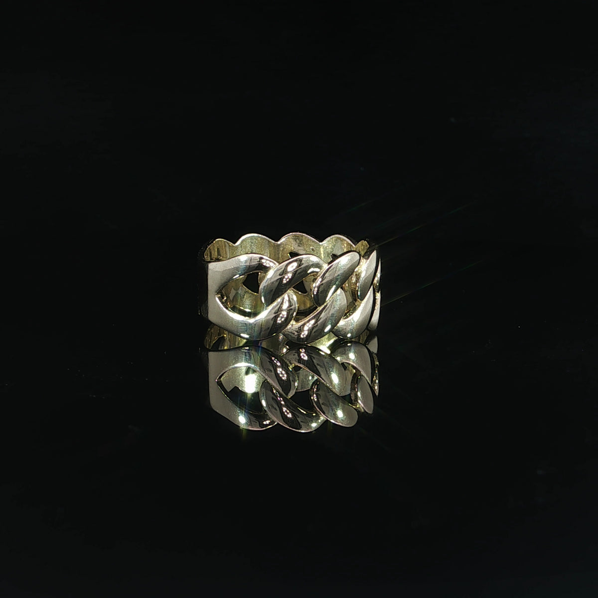 Side view of a 14K yellow gold Cuban link ring featuring a 9.5mm wide interlocking chain design with bold, polished links and a reflective finish.