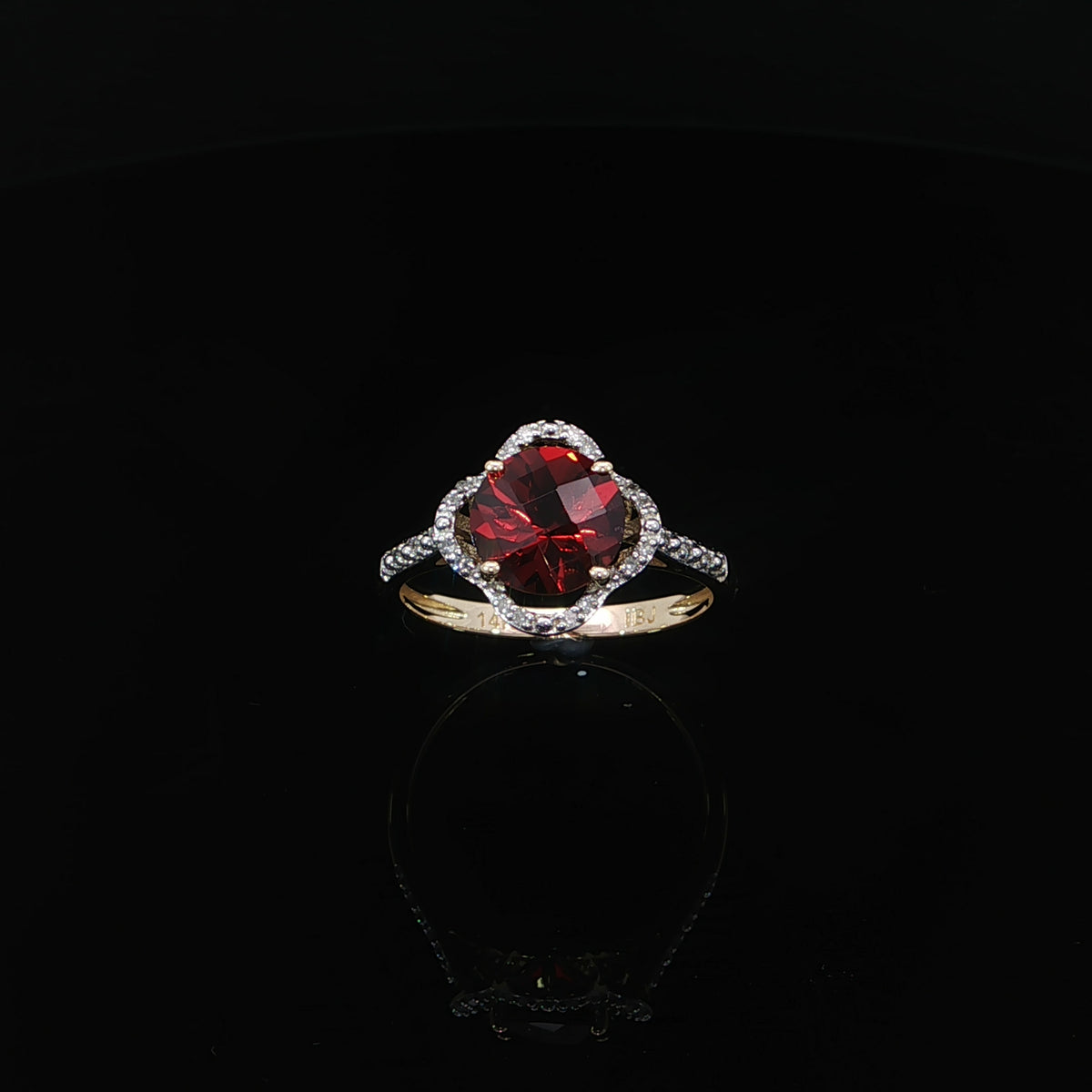 Front view showing the scalloped halo and diamond band of a 14K yellow gold garnet ring, 0.10 CTW.