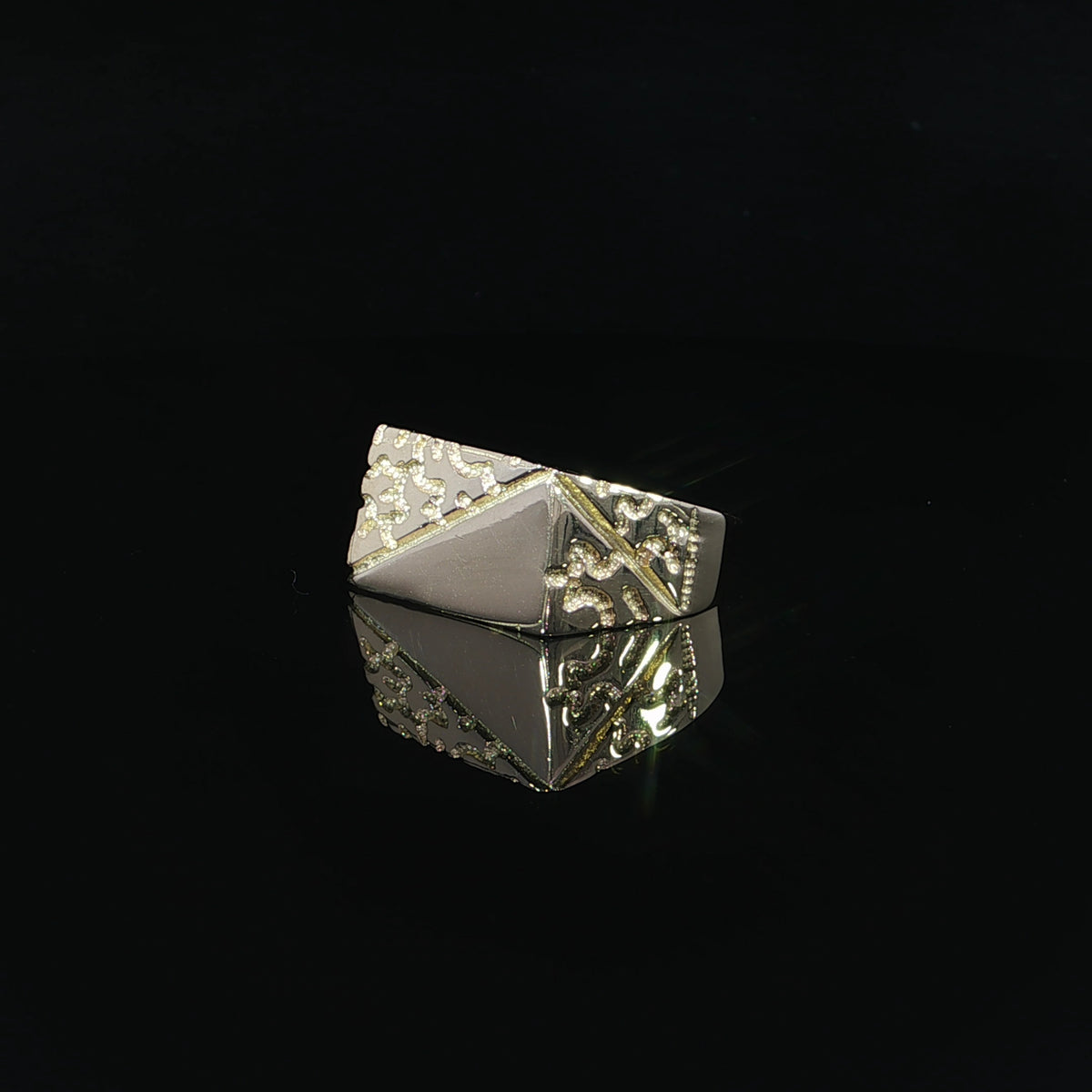 Rectangular 14K yellow gold ring with an asymmetric diagonal design combining raised nugget patterns and a reflective polished surface.