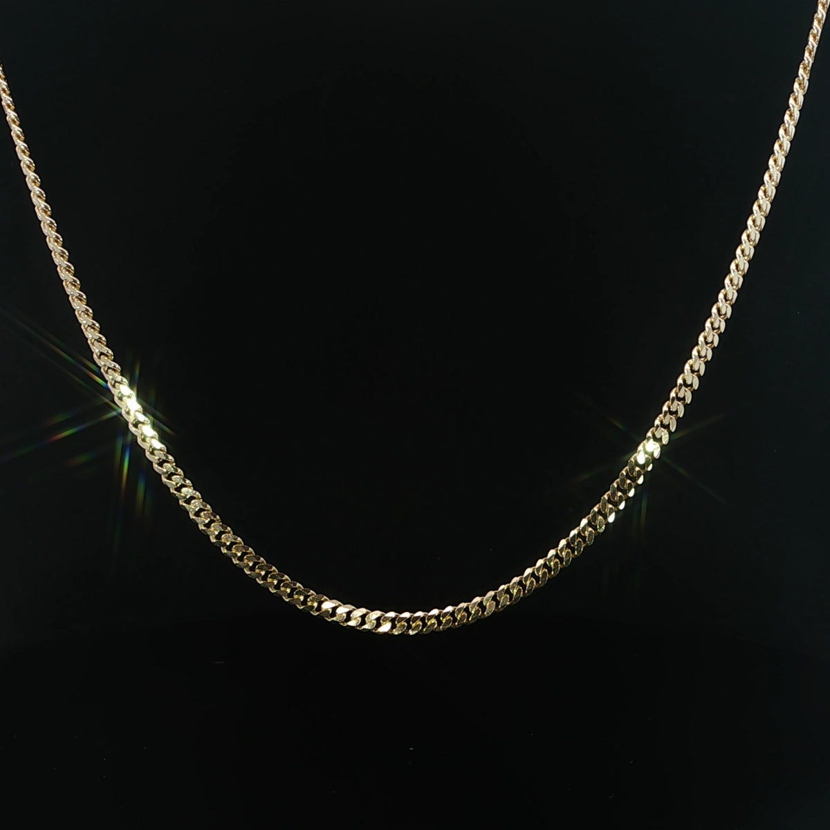 Front view of a polished 14K yellow gold Miami Cuban necklace