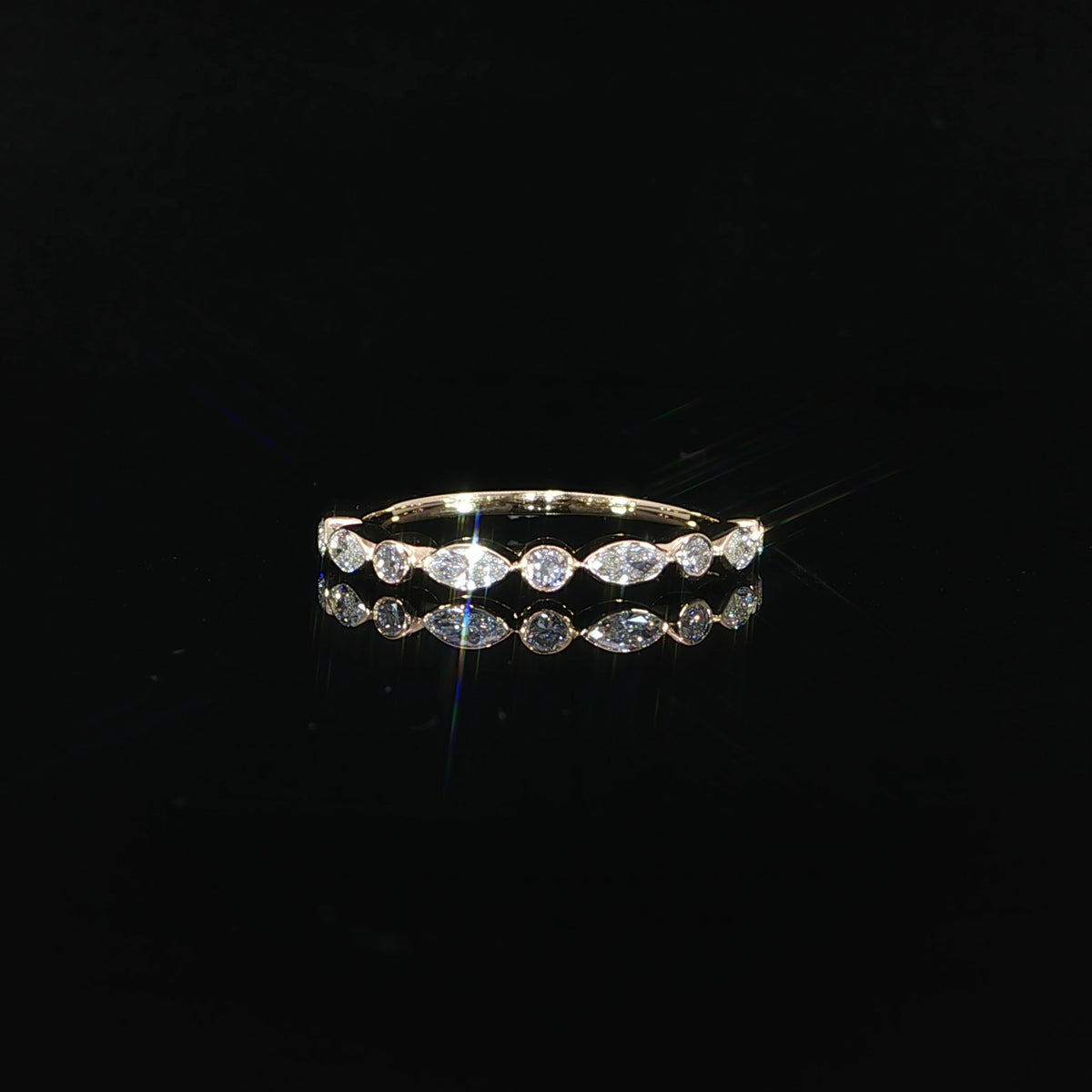 Front view of a 14K yellow gold diamond band featuring alternating marquise and round bezel set lab grown diamonds totaling 0.41 CTW.