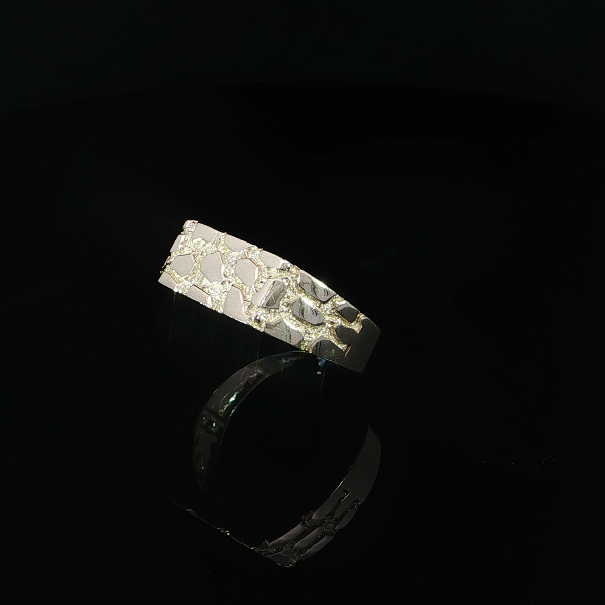 Three-quarter view of a 14K yellow gold rectangular nugget ring displaying its textured top, patterned shoulders, and substantial band design.