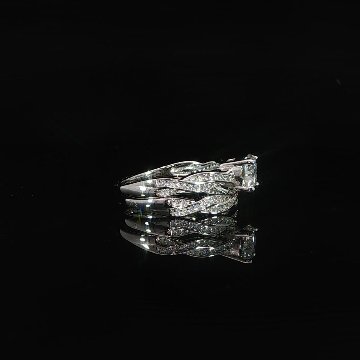 Sterling silver moissanite engagement ring with matching twisted wedding band