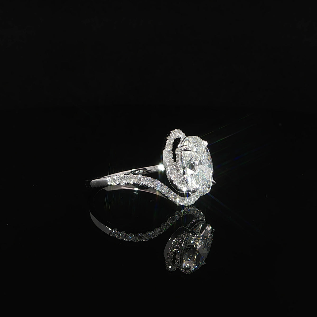 2.03-carat oval lab-grown diamond engagement ring with an encasing halo in 14K white gold.