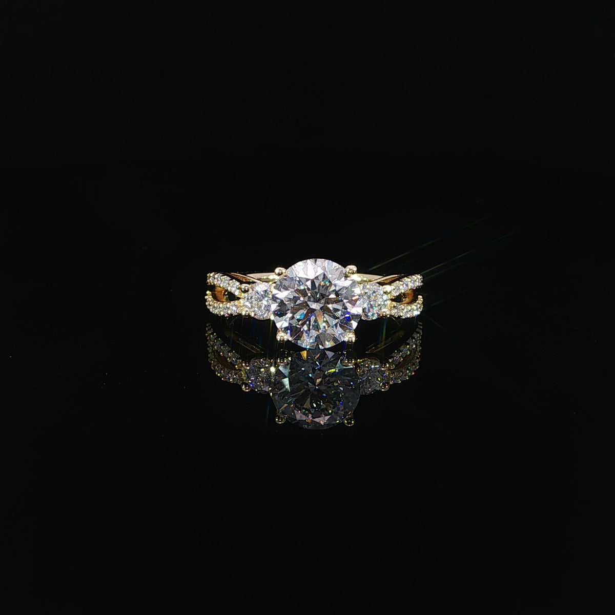 Front view of a 2.10 carat round diamond ring with side stones and a split shank