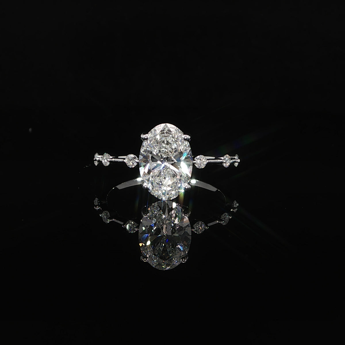 2-carat oval diamond engagement ring in 14K gold with a delicate diamond station band.