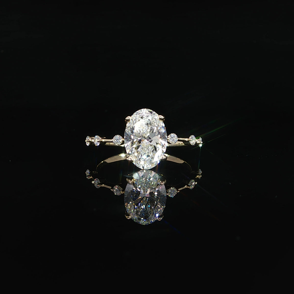 Front view 2-carat oval diamond engagement ring crafted in polished 14K yellow gold.