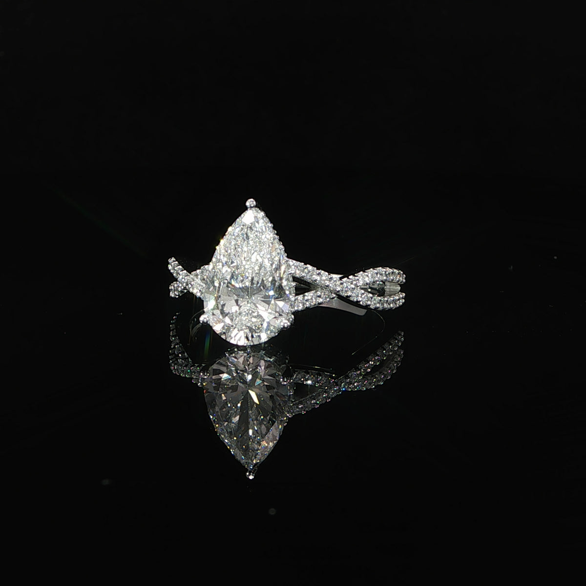 2-carat pear-shaped lab-grown diamond engagement ring with a hidden halo and twist band in 14K gold.
