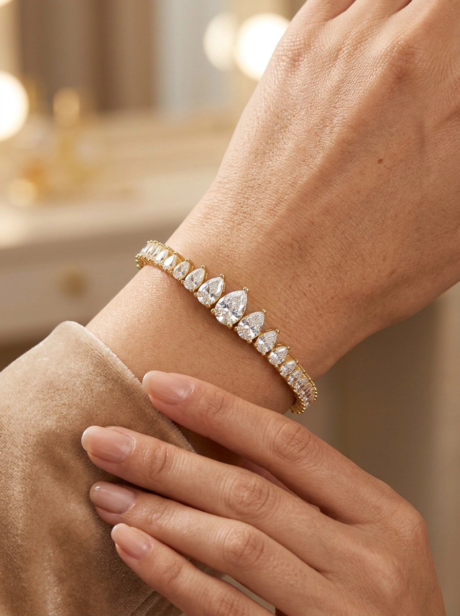 Graduated pear moissanite tennis bracelet crafted in polished 925 sterling silver.