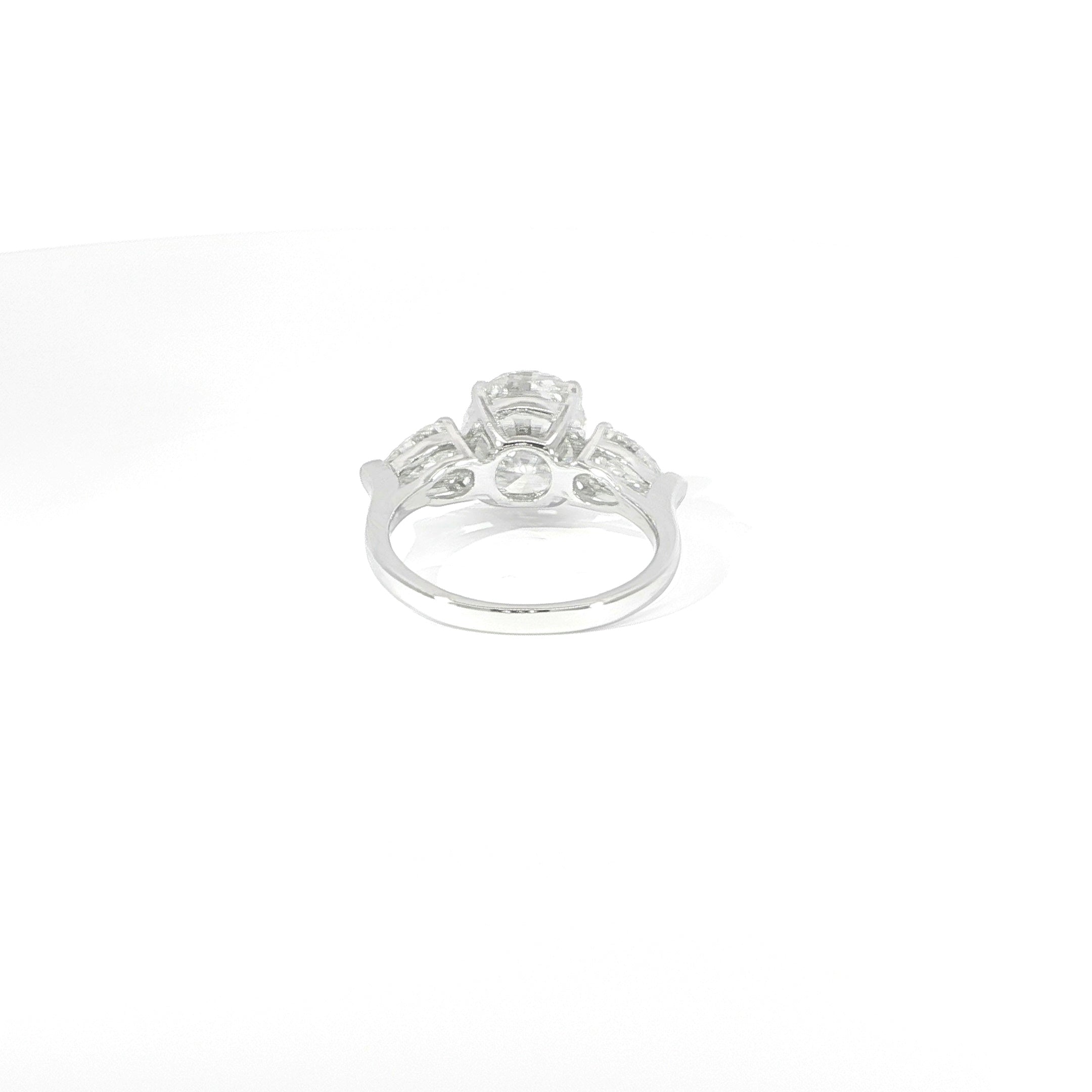 Three-stone oval moissanite ring with brilliant pear side stones