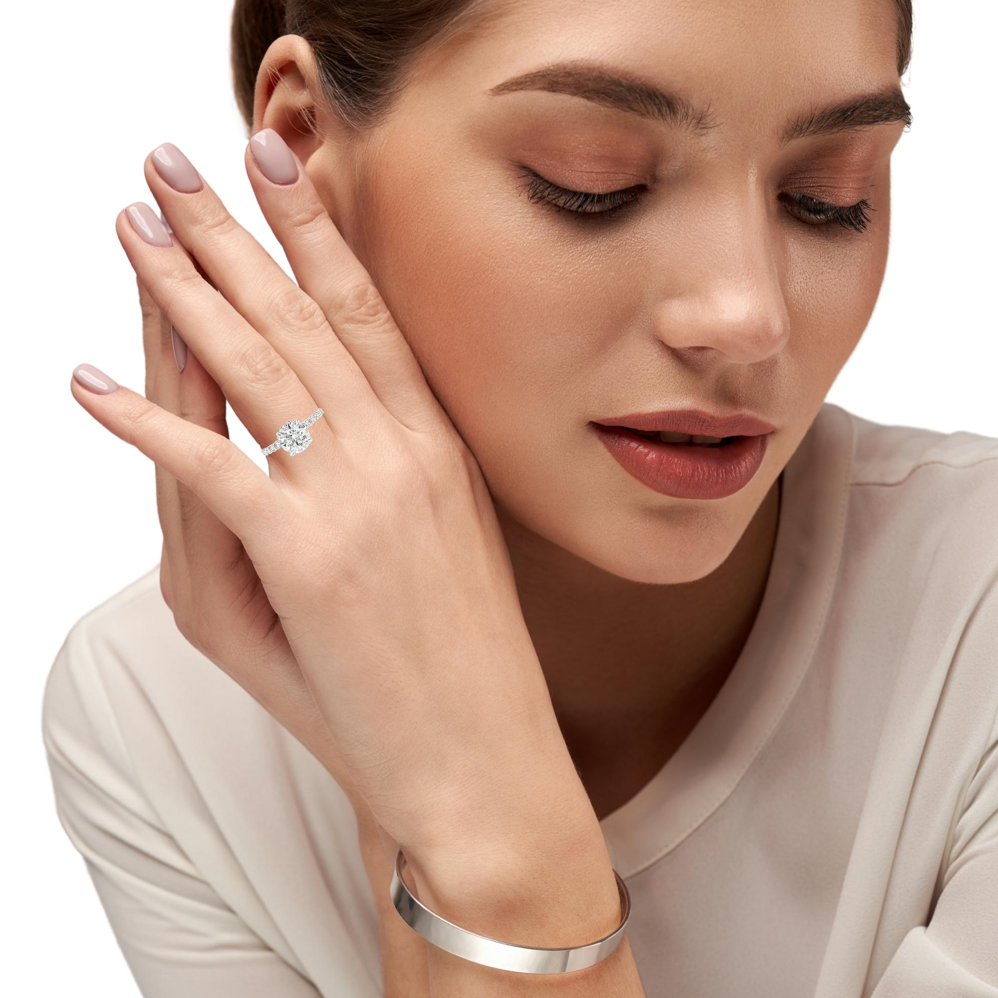 Model showing classic solitaire engagement ring with hidden halo